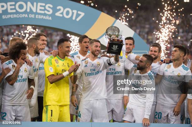 Sergio Ramos of Real Madrid CF celebrates with teammates with the Supercopa de Espana trophy after beating FC Barcelona 2-0 on aggregate in the...