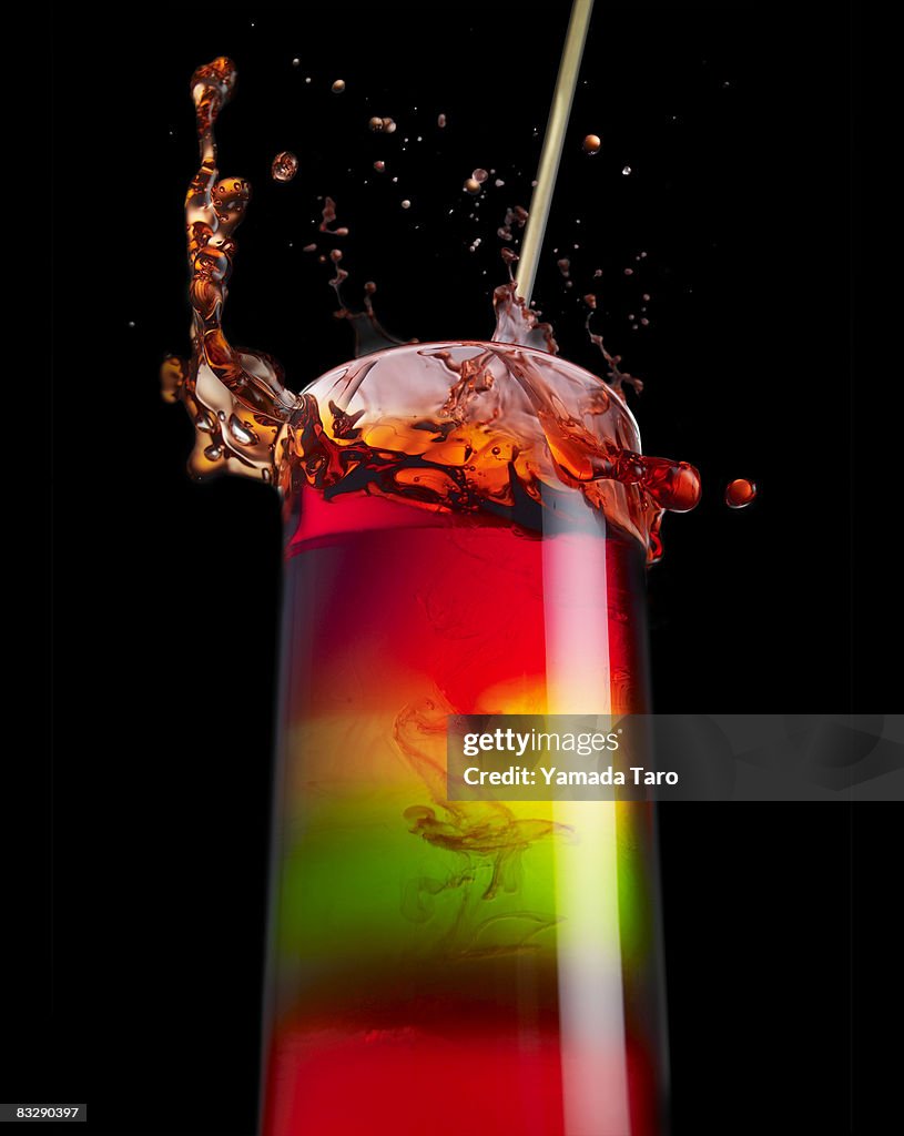 Spring red water from colorful water glass