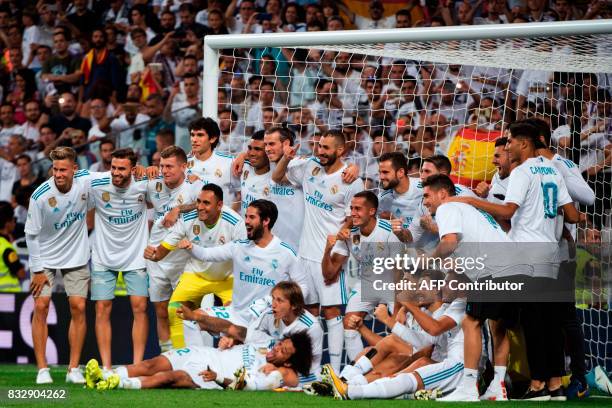 Real Madrid's players pose as they celebrate their Supercup after winning the second leg of the Spanish Supercup football match Real Madrid vs FC...