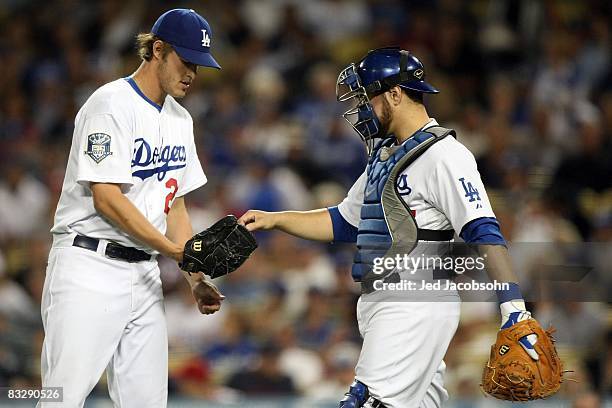 Clayton Kershaw of the Los Angeles Dodgers is handed the ball by catcher Russell Martin in the first inning against the Philadelphia Phillies in Game...