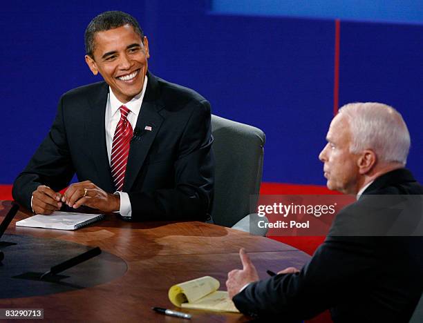 Democratic presidential candidate U.S. Sen. Barack Obama listens as Republican presidential candidate U.S. Sen. John McCain speaks during the third...