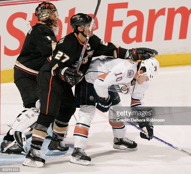 Shawn Horcoff of the Edmonton Oilers gets pushed out of the crease by Scott Niedermayer of the Anaheim Ducks during the game on October 15, 2008 at...