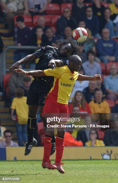 Portsmouth's Linvoy Primus and Watford's Damien Francis battle for the ball in the air