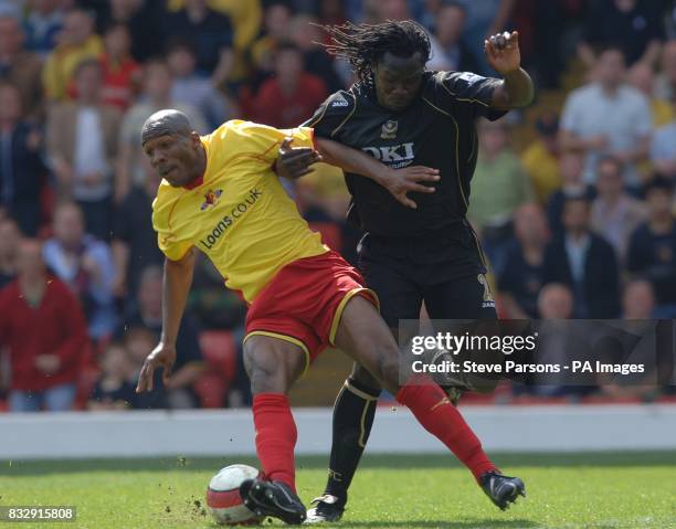 Portsmouth's Linvoy Primus and Watford's Damien Francis battle for the ball