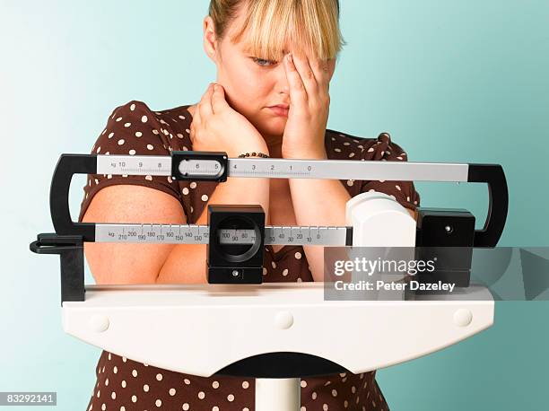 obese teenager on scales - fat girls stock-fotos und bilder