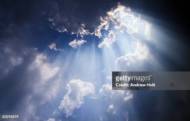 sun rays breaking through cloud - spirituality stock pictures, royalty-free photos & images