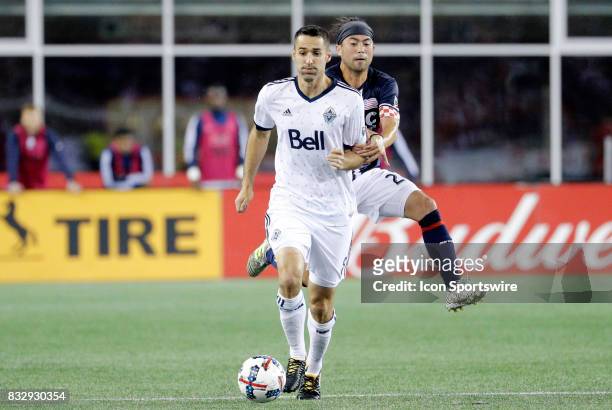 New England Revolution midfielder Lee Nguyen catches up to Vancouver Whitecaps midfielder Andrew Jacobson during an MLS match between the New England...