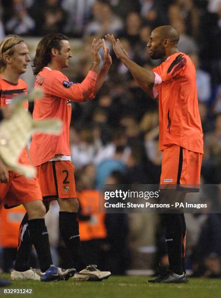 Sevilla's Francisco Javi Navarro and Frederic Kanoute celebrate at the end of the match