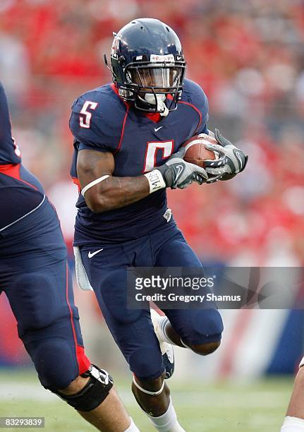 Nicolas Grigsby of the Arizona Wildcats carries the ball during the game against the Washington Huskies on October 4, 2008 at Arizona Stadium in...