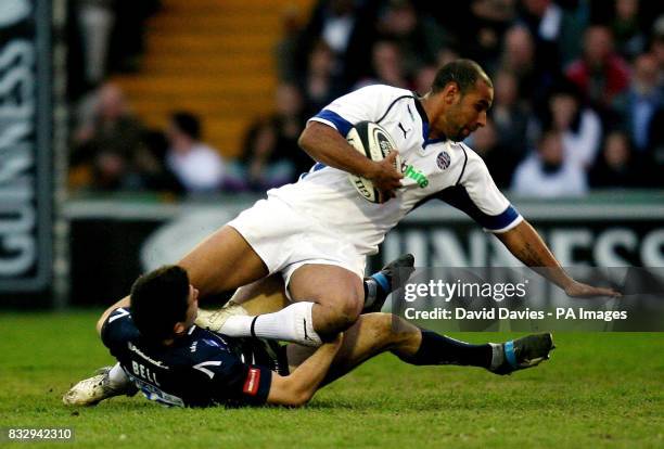 Bath's Chev Walker is tackled by Sale's Chris Bell during the Guinness Premiership match at Edgeley Park, Stockport.