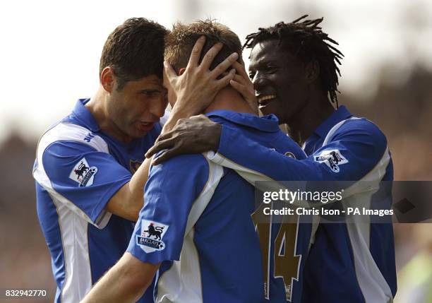 Portsmouth's Matthew Taylor celebrates scoring his sides second goal of the game, with team mates Dejan Stefanovic and Benjani Mwaruwari.