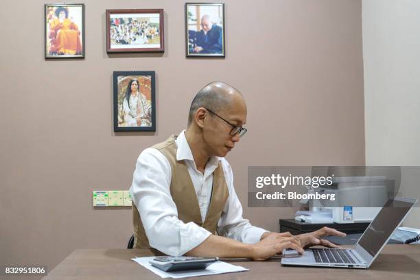 Lim Tze Cheng, chief executive officer of Inter-Pacific Asset Management Sdn., works on his computer in his office in Kuala Lumpur, Malaysia, on...