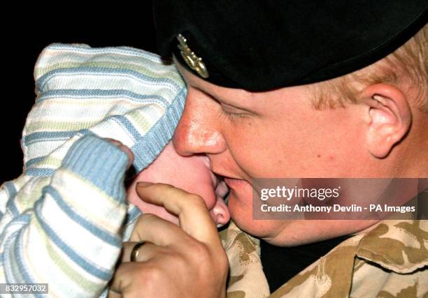 Private Jason Swindley from the 1st Battalion The Staffordshire Regiment, sees son Brandon, 14 weeks, for the first time on his return to camp in...