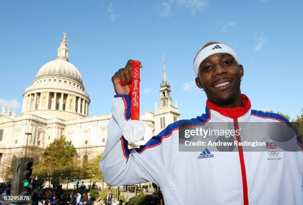 Triple-jumper Phillips Idowu poses with his Olympic silver medal in front of St Paul's Cathedral during the Olympic and Paralympic Heroes Parade on...