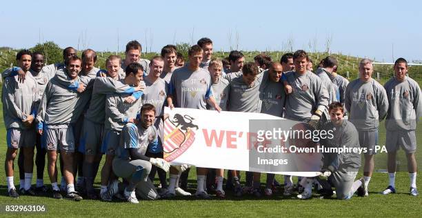 Sunderland players celebrate promotion to the Premiership during a training session at Whitburn , Sunderland.