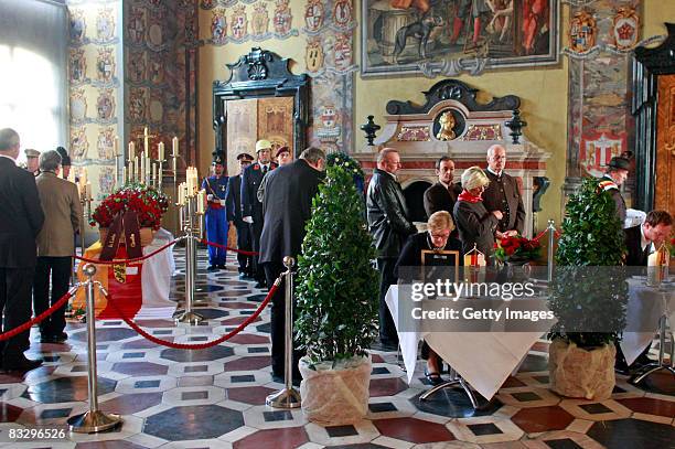 People sign the book of condolence beside the coffin of Austrian far-right leader Joerg Haider in the Grosser Wappensaal of the Landhaus Klagenfurt...