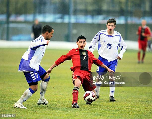 Daniel O'Shaughnessy of Finland and Nikolai Alho compete with midfielder OezkanYildimir of Germany during the U16 international friendly match...