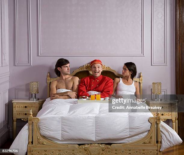 an enthusiastic valet serve breakfast in bed. - bellhop stockfoto's en -beelden