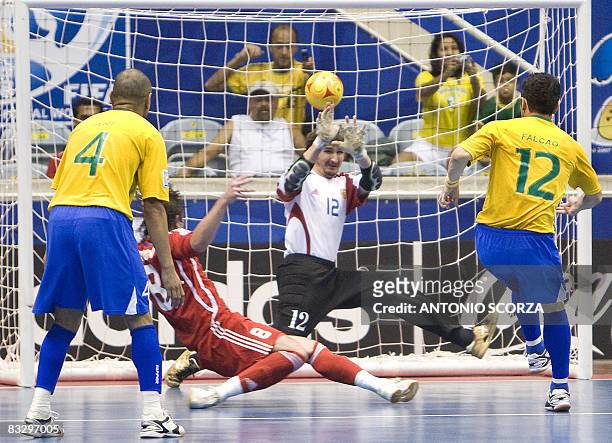 Brazil's futsal player Falcao kicks to score against the goal guarded by Russia's goalkeeper Sergei Zuev on October 16, 2008 during their FIFA Futsal...