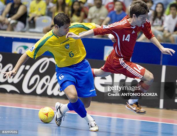 Brazil's futsal player Gabriel vies for the ball with Russia's Damir Khamadiev on October 16, 2008 during their FIFA Futsal World Cup semifinal match...