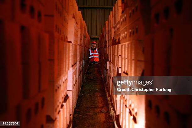 Worker checks on bricks ready to be fired at the Accrington Nori brick factory on 16 October, 2008 in Accrington, England. The world famous brick...