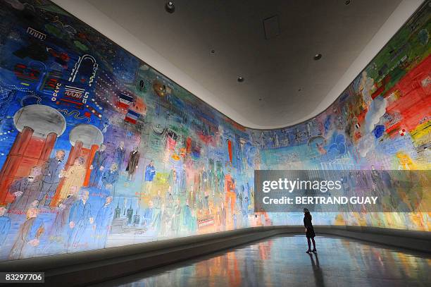 Woman looks at a fresco by French Fauvist painter Raoul Dufy entitled "La Fée électricité" , on October 16, 2008 during the exhibition "Raoul Dufy,...