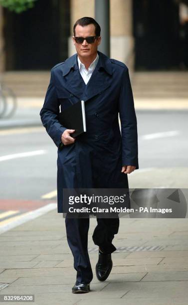 Banking heir Matthew Mellon arrives at Southwark Crown Court in London where he is accused of of spying on his former wife Tamara Mellon, who owns...