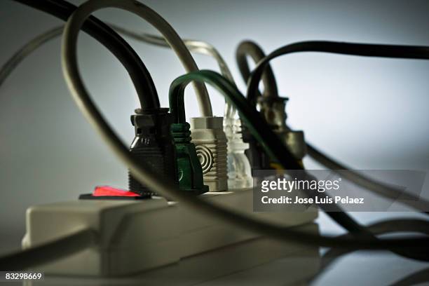 a power surge full of plugs - power strip stock pictures, royalty-free photos & images