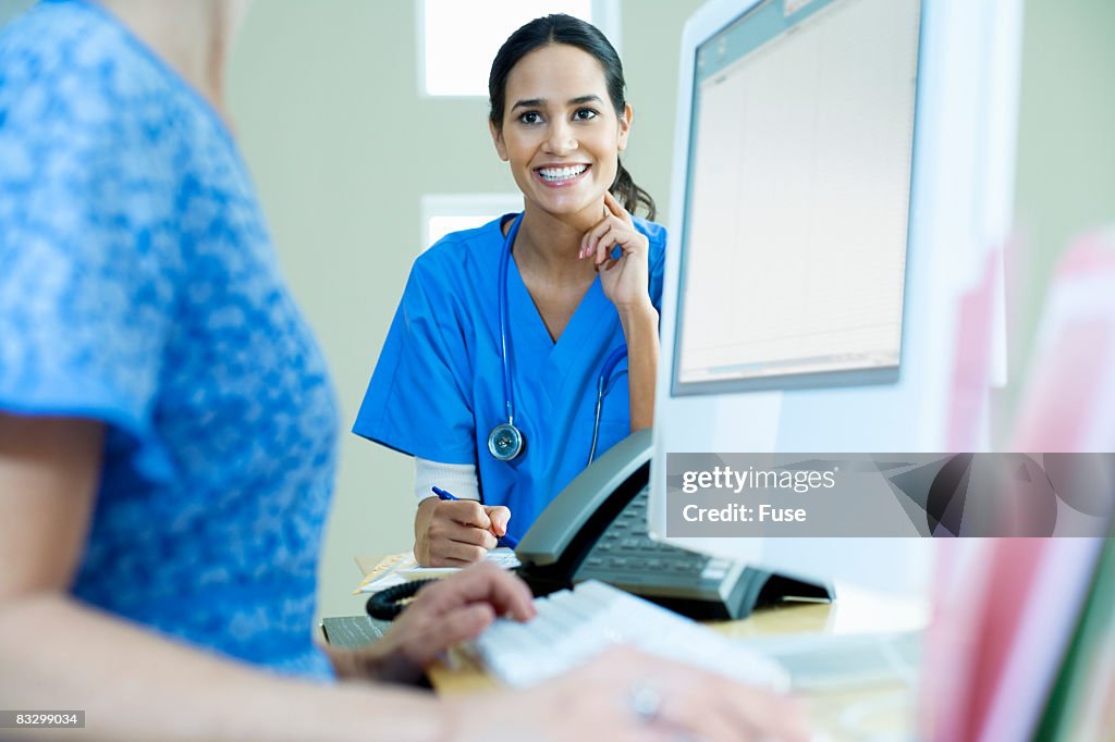 Nurse Ringing Computer Nurse On Computer High-Res Stock Photo - Getty Images