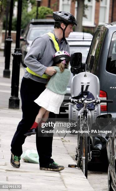 Conservative party leader David Cameron prepares to cycle his daughter Nancy to school on his way to the House of Commons, London.