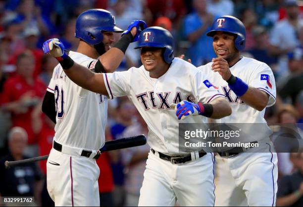 Adrian Beltre of the Texas Rangers celebrates with Nomar Mazara of the Texas Rangers and Elvis Andrus of the Texas Rangers after hitting a two run...