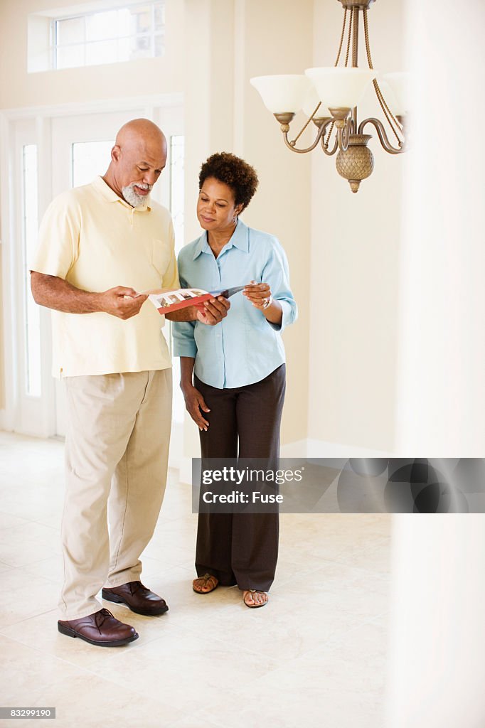 Couple Looking at Layout of New House