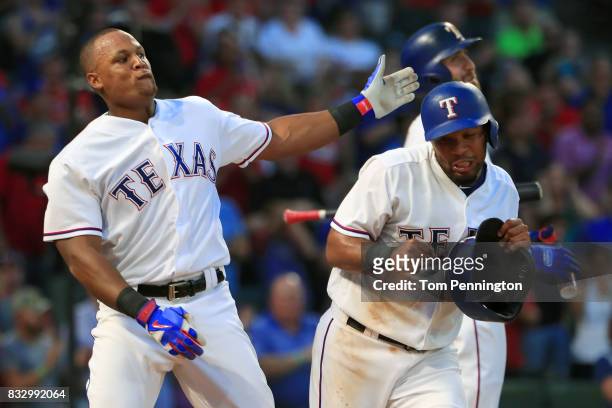 Adrian Beltre of the Texas Rangers takes a swipe at Elvis Andrus of the Texas Rangers after Andrus took his batting helmet in the bottom of the third...