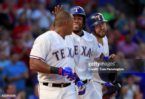 Adrian Beltre of the Texas Rangers celebrates with Nomar Mazara of the Texas Rangers and Elvis Andrus of the Texas Rangers after hitting a two run...