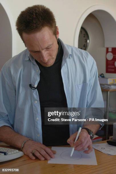 British born DVD shop owner Simon Russell draws his version of the e-fit of a man that he was shown last Saturday by police in Praia Da Luz,...