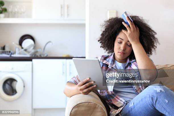 woman with digital tablet having problems - credit card debt stock pictures, royalty-free photos & images