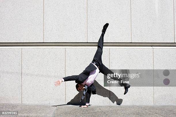 businessman doing a cartwheel - cartwheel stock pictures, royalty-free photos & images