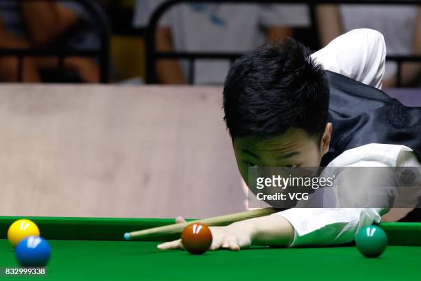Lyu Haotian of China plays a shot during a qualifying match against John Higgins of Scotland on day one of Evergrande 2017 World Snooker China...