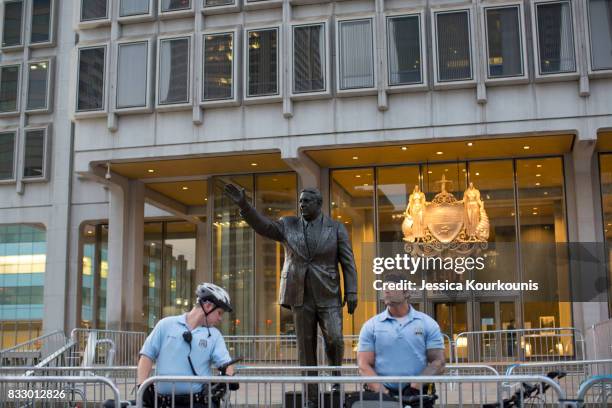 Police officers guard a statue of former Philadelphia mayor Frank Rizzo as protesters march against white supremacy August 16, 2017 in downtown...