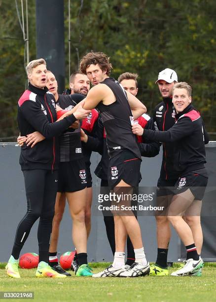 Nick Riewoldt of the Saints, Tom Hickey of the Saints and their teammates embrace during a training exercise during a St Kilda Saints AFL training...