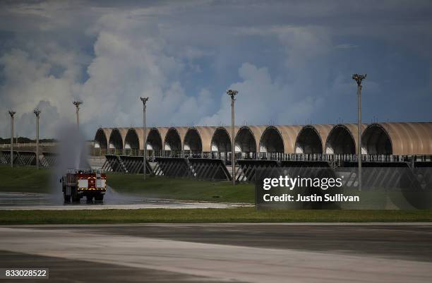 Air Force fire truck sprays water near plane hangars at Andersen Air Force base on August 17, 2017 in Yigo, Guam. The American territory of Guam...