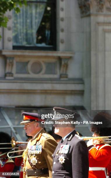 Spectator watches on from a window as, from left, General Sir Richard Dannatt, Chief of General Staff and Sir Ronnie Flanagan, Chief Inspector of...