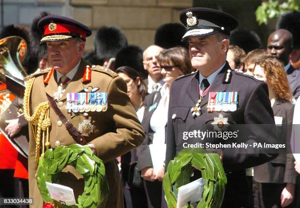 Spectator watches on from a window as, from left, General Sir Richard Dannatt, Chief of General Staff and Sir Ronnie Flanagan, Chief Inspector of...