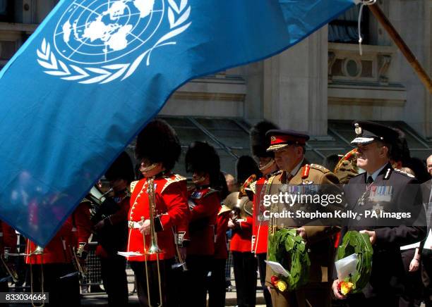 Spectator watches on from a window as, from left, General Sir Richard Dannatt, Chief of General Staff and Sir Ronnie Flanagan, Chief Inspector of...