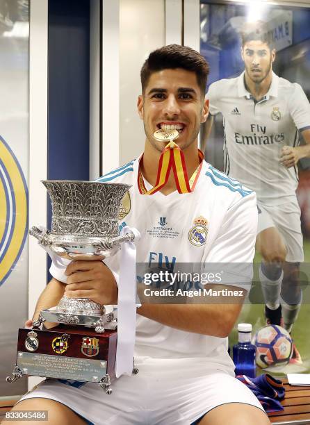 Marco Asensio of Real Madrid celebrates with the trophy after the Supercopa de Espana Final second leg match between Real Madrid and FC Barcelona at...