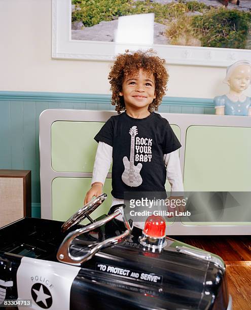 portrait of young boy smiling with toy police car. - police car stock pictures, royalty-free photos & images