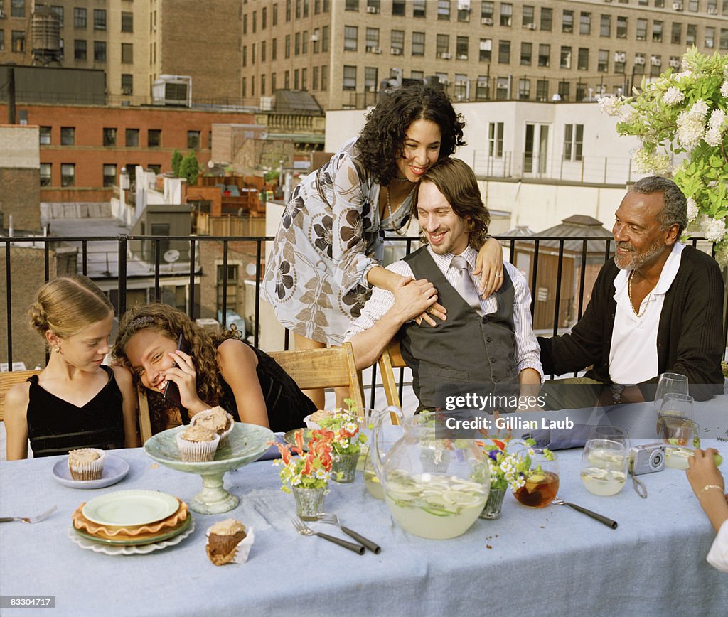 Generations of family having dinner on rooftop.