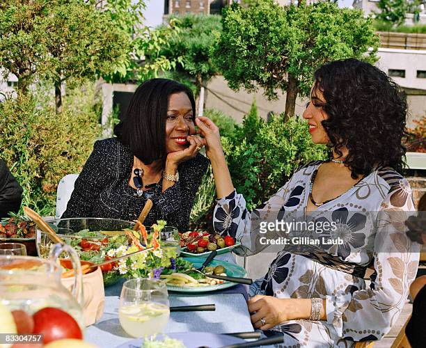 mother and daughter having dinner on nyc rooftop. - black family reunion stock pictures, royalty-free photos & images