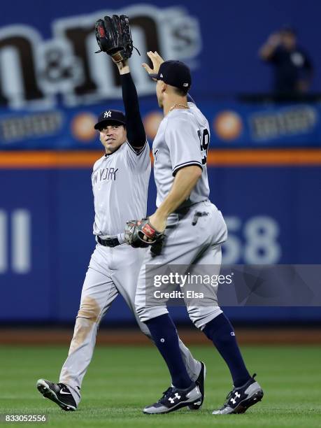 Jacoby Ellsbury and Aaron Judge of the New York Yankees celebrate the 5-3 win over the New York Mets during interleague play on August 16, 2017 at...