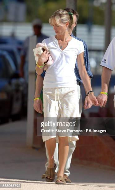Kate McCann walks to the church in Praia Da Luz, Portugal, carrying a childrens soft toy and book titled 'We're Going on a Bear Hunt'. Madeleine...